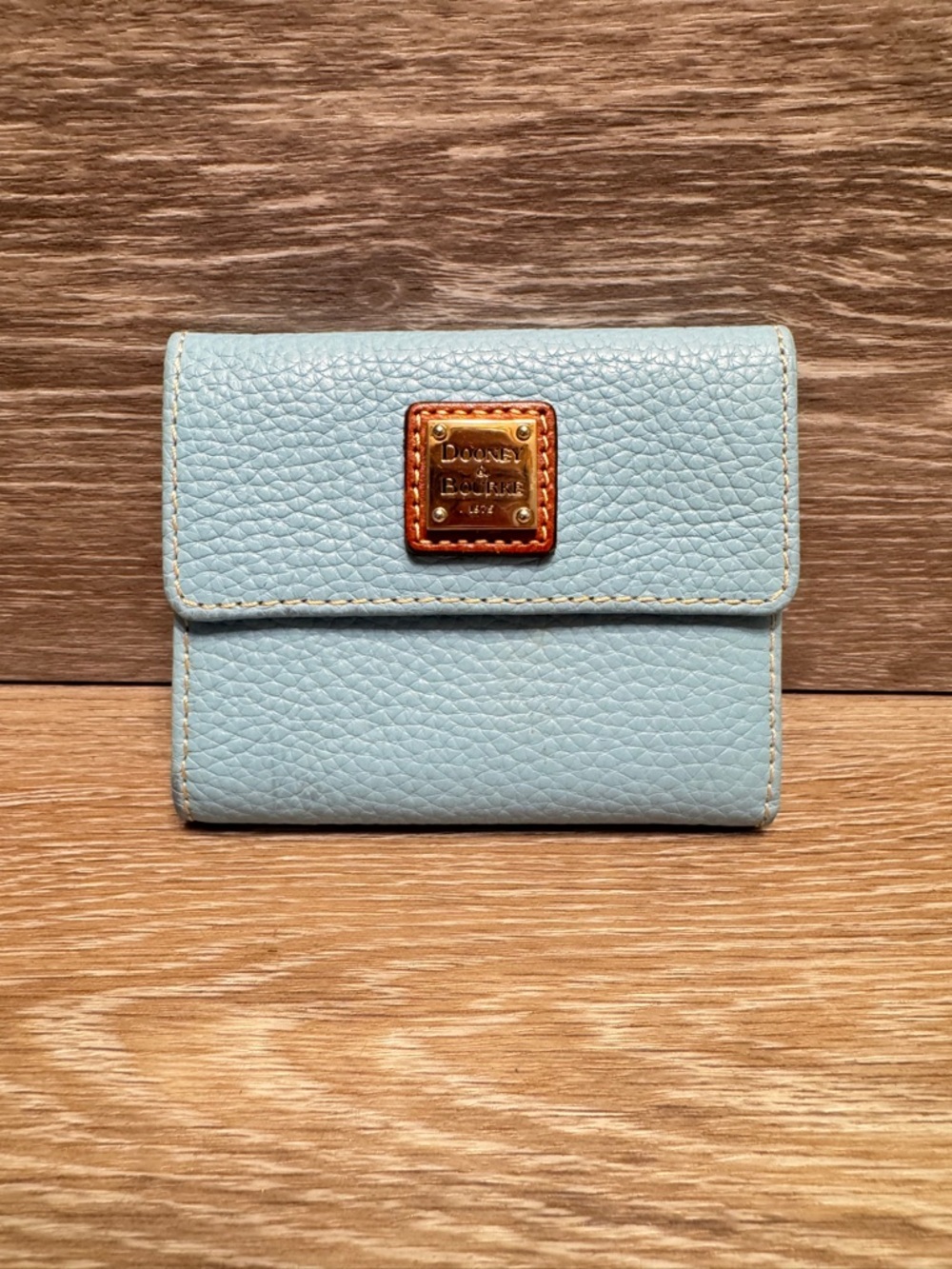 Dooney and Burke pebble grain small flap wallet Sky Blue metal tag